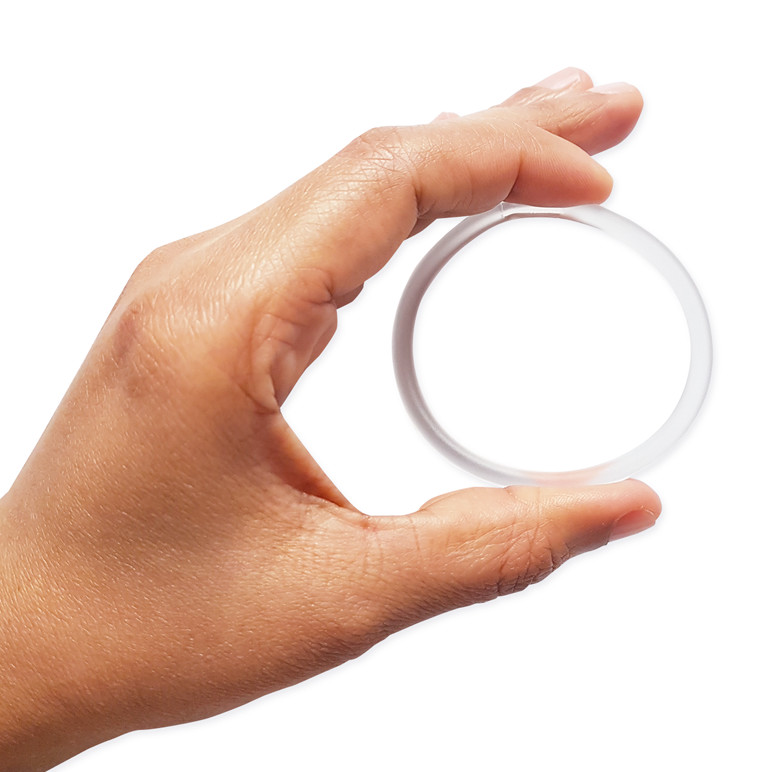 A hand holding a vaginal ring which is a contraceptive for women